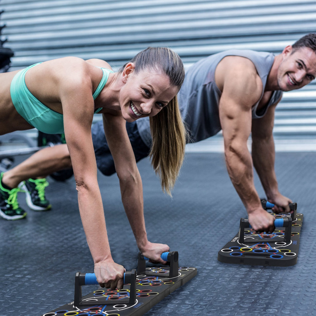Two people doing push-ups on a fitness board outdoors.